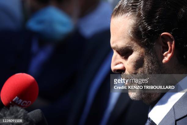 Former Lebanese prime minister Saad Hariri, reacts and speaks to the press as he leaves the UN-backed Special Tribunal for Lebanon at Leidschendam on...