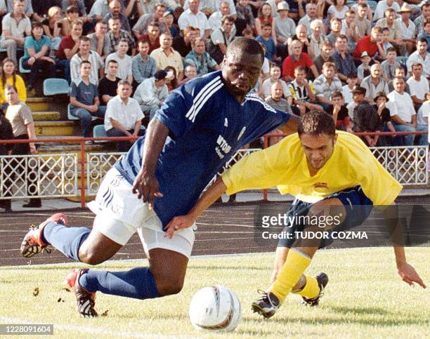 Asamoah Geralo from Shalke 04 fights for the ball with Martin Andrei ,Dacia Moldova in Chisinau on 19 July 2003. The match finished 1-0 for the...