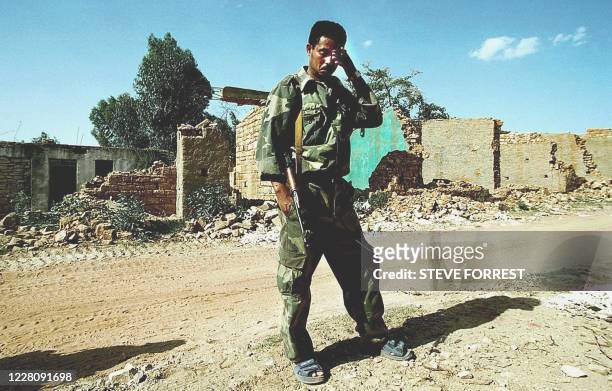 An Eritrean soldier stands in front of the destroyed Eritrean town of Zalambessa, 4km from the front lines and 136 km from the capital Asmara, 24 May...