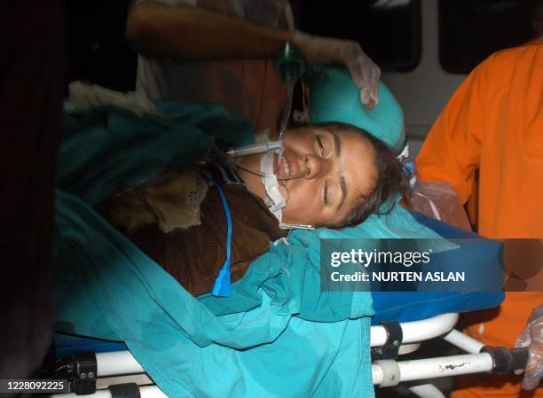 Wounded child lays on a stretcher as he gets first aid on May 5, 2009 after masked gunmen stormed late on May 4 a wedding party in the village of...