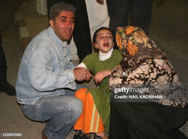 People, who lost relatives in an attack on May 4, 2009 in the Turkish village of Bilge, mourn in front of a hospital in the Kurdish city of Mardin on...