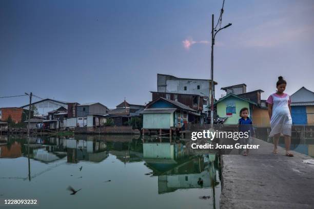 The floodwaters in Kampung Teko, Jakarta, cannot wash out to sea because the area lies below sea level. Jakarta is subsiding at record rates, thanks...