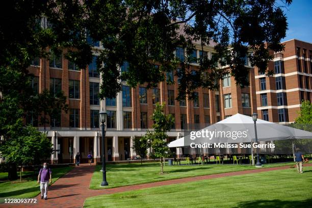 Students and faculty walk through an open area outside the School of Medicine on the campus of the University of North Carolina at Chapel Hill on...