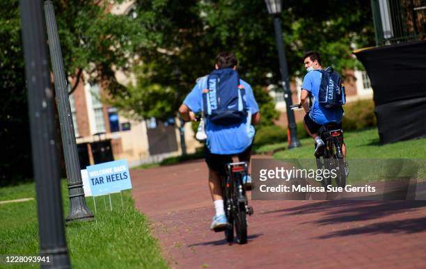 Student-athletes ride through the campus of the University of North Carolina at Chapel Hill on August 18, 2020 in Chapel Hill, North Carolina.The...