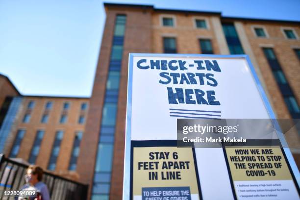 Placards advise physical distancing guidelines due to the coronavirus pandemic while directing incoming freshman moving into a campus dormitory at...