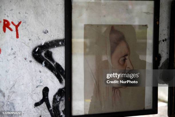 Bambang's paintings are displayed on the wall in his street paint studio during the celebration of Indonesia's 75th Independence Day in Jakarta,...