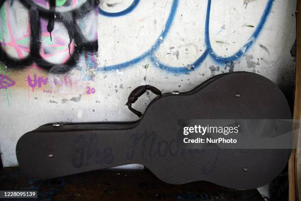 Bambang's gitar in the hardcase reads The Moonlight is seen on his street paint studio during the celebration of Indonesia's 75th Independence Day in...