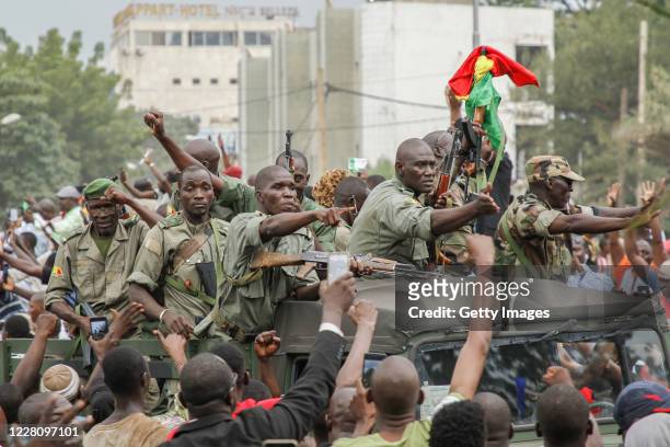 Crowds cheer as soldiers parade in vehicles along the Boulevard de l'Independance on August 18, 2020 in Bamako, Mali. President Ibrahim Boubacar...
