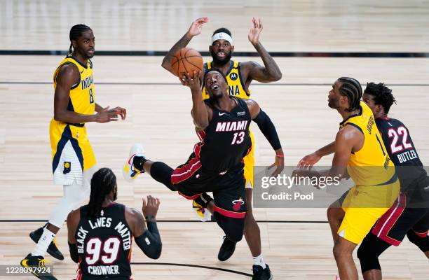 Bam Adebayo of the Miami Heat makes an off-balanced shot against Justin Holiday, JaKarr Sampson and T.J. Warren of the Indiana Pacers during the...