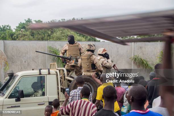 Soldiers on a military vehicle, moving towards capital Bamako, are being greeted by citizens gathered at Independence Square in Bamako, Mali on...