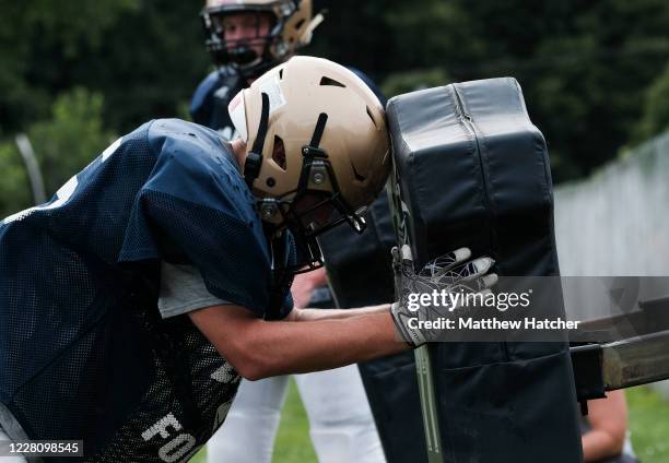 Football players from Lancaster High School take part in offensive and tackle training during football practice on August 18, 2020 in Lancaster,...