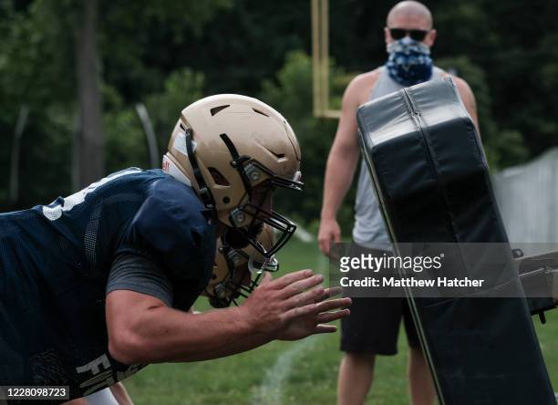 Football players from Lancaster High School take part in offensive and tackle training during football practice on August 18, 2020 in Lancaster,...