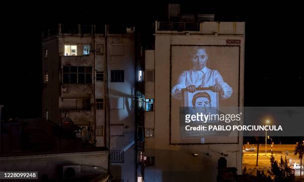 View of a portrait taken by the group Imagenes del Silencio of Uruguayan DJ Paola Dalto holding a picture of Abel Ayala, who disappeared during the...