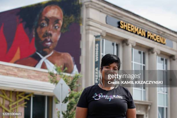 Baboonie Tatum, owner of the Rise and Grind Cafe, poses outside her coffee shop in Milwaukee, Wisconsin, on August 15, 2020. - Tatum's shop is...