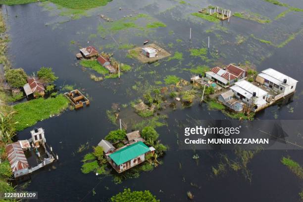 In this aerial photo inundated village houses are seen in Savar on August 19, 2020. - The death toll from the torrential monsoon rains across South...
