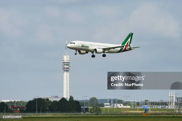 Alitalia Airbus A320 aircraft as seen on final approach flying and landing at Polderbaan runway in Amsterdam Schiphol AMS EHAM international airport...