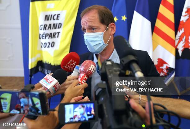 Tour de France director Christian Prudhomme wearing a face mask gives a press conference to present sanitary measures over the COVID-19 pandemic put...