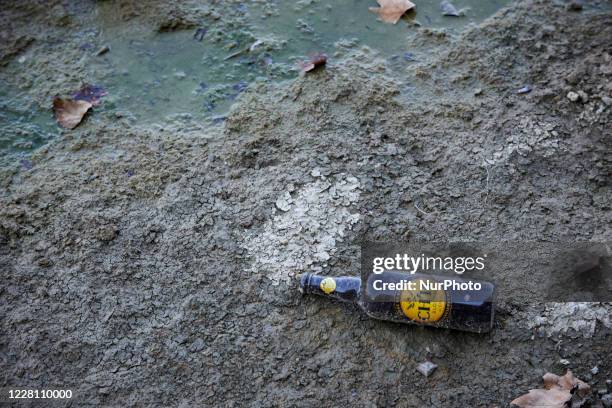 An empty bottle of beer lies on the Garonne' riverbed. The Garonne river is near its record low levels due to a lack of rain since the beginning of...