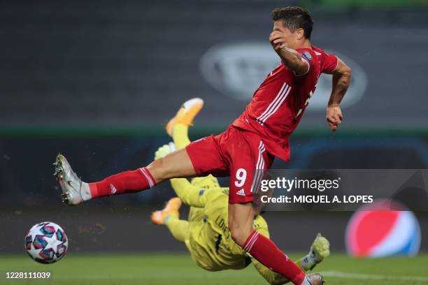 Lyon's Portuguese goalkeeper Anthony Lopes stops a shot on goal by Bayern Munich's Polish forward Robert Lewandowski during the UEFA Champions League...