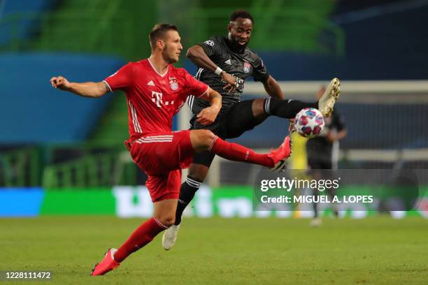 Bayern Munich's German defender Niklas Suele challenges Lyon's French forward Moussa Dembele during the UEFA Champions League semi-final football...