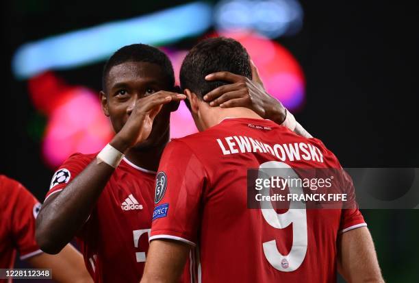 Bayern Munich's Polish forward Robert Lewandowski celebrates with Bayern Munich's Austrian defender David Alaba after scoring a goal during the UEFA...