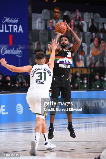 Troy Daniels of the Denver Nuggets shoots the ball against the Utah Jazz during Round One, Game Two of the NBA Playoffs on August 19, 2020 at the...