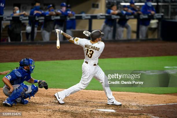 Manny Machado of the San Diego Padres hits a walk-off grand slam in the 10th inning against the Texas Rangers at Petco Park on August 19, 2020 in San...