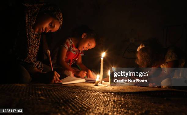 https://media.gettyimages.com/id/1228117163/photo/palestinian-children-do-their-homework-using-candles-during-a-power-cut-after-gazas-sole.jpg?s=612x612&w=gi&k=20&c=V8IPHsr4XbVHYZ7y8o_Ylnayf4l5fZSrMBHHYPM7LYQ=