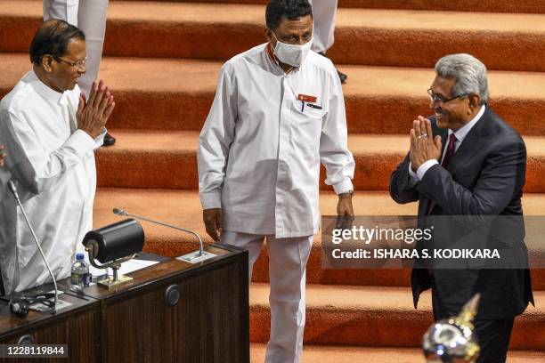 Sri Lankan President Gotabaya Rajapaksa greets former president Maithripala Sirisena at the national Parliament in Colombo on August 20, 2020. - Sri...