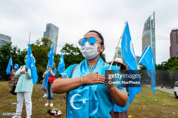 Woman is signing the Uyghur national hymn, during the demonstration 'Freedom for Uyghurs' in The Hague, Netherlands on August 20th, 2020.