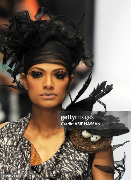 Model presents a creation by Pakistani designer Umer Saeed on the last day of the Karachi Fashion Week on April 9, 2010. The event is scheduled to...