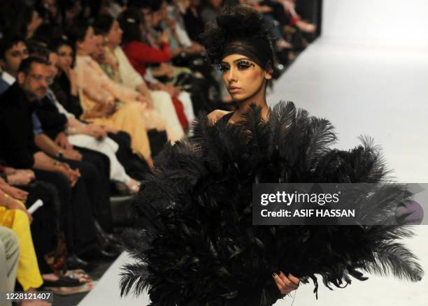 Model presents a creation by Pakistani designer Umer Saeed on the last day of the Karachi Fashion Week on April 9, 2010. The event is scheduled to...