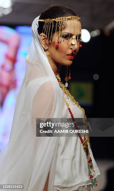 Pakistani model presents a creation by Pakistani designer Shafaq Habib during the first day of Islamabad Fashion Week in Islamabad on January 27,...