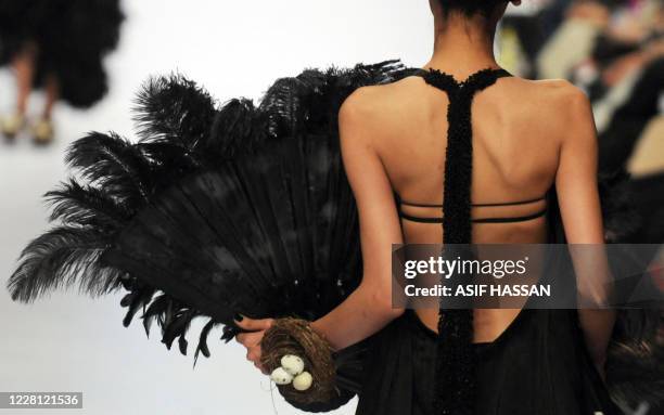 Model presents a creation by Pakistani designer Umer Saeed on the last day of the Karachi Fashion Week on April 9, 2010. The event is scheduled to...