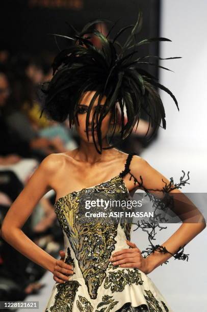 Model presents a creation by Pakistani designer Umer Saeed on the last day of the Karachi Fashion Week on April 9, 2010. The event is scheduled to...