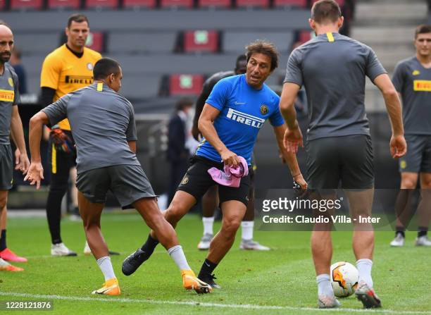 Head coach FC Internazionale Antonio Conte and Alexis Sanchez compete for the ball during a FC Internazionale training session at RheinEnergieStadion...