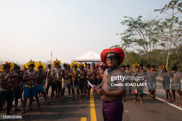 Members of the Kayapo indigenous group stand while blocking highway BR163 during a protest in the outskirts of Novo Progresso in Para State, Brazil,...