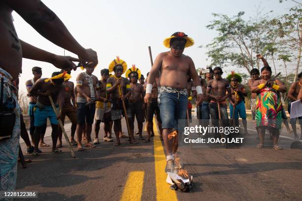 Members of the Kayapo indigenous burn a FUNAI document while blocking highway BR163 during a protest in the outskirts of Novo Progresso in Para...