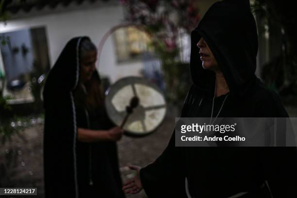 First degree Wicca priestess listens while Jussara Gabriel a Wiccan High priestess uses a ritual drum during the Imbolc, the seasonal sabbat in honor...