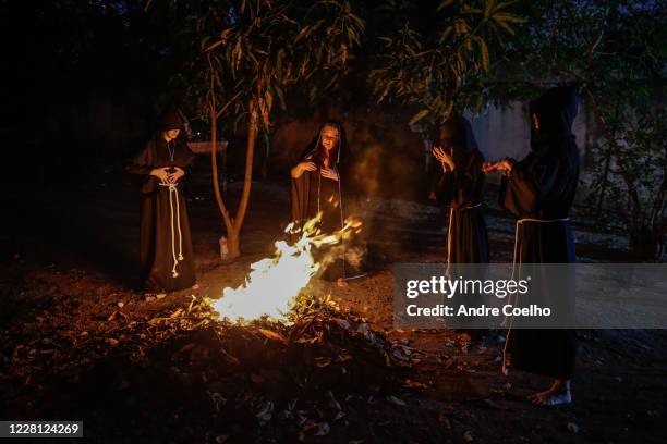 Jussara Gabriel a Wiccan High priestess and first degree priestesses pray around a fire pit during the Imbolc, the seasonal sabbat in honor of...