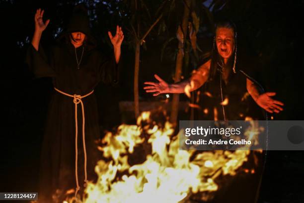 Jussara Gabriel a Wiccan High priestess and first degree priestesses pray around a fire pit during the Imbolc, the seasonal sabbat in honor of...