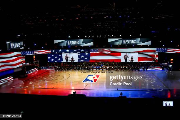 The Oklahoma City Thunder and the Houston Rockets kneel for the national anthem before game two in the first round of the 2020 NBA Playoffs at...