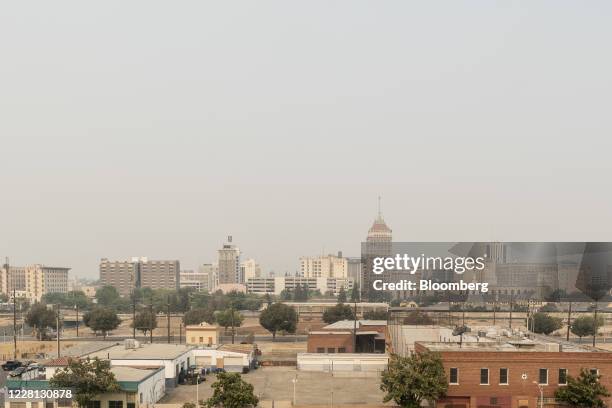 Smoke surrounds downtown Fresno, California, U.S., on Wednesday, Aug. 19, 2020. More than 360 blazes are burning in California, forcing mass...