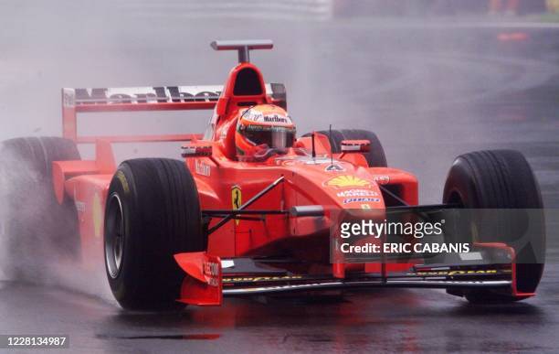 Irish Eddie Irvine speeds his Ferrari on the wet racetrack, 12 September in Monza, during the second free practice session, one day before the...