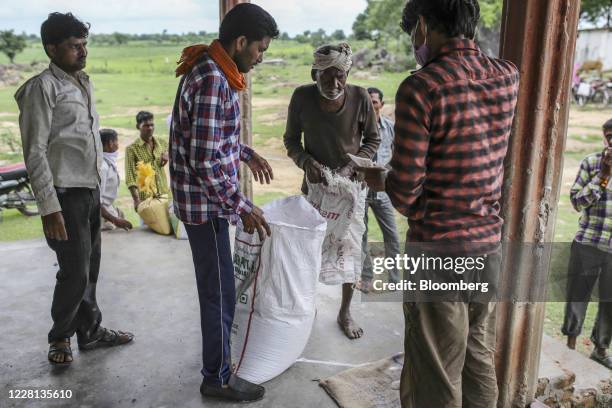 Man collects a subsidized ration of grain from a state-run distribution store in a village in Tikamgarh district, Madhya Pradesh, India, on Friday,...