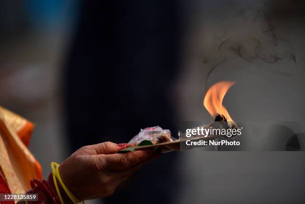 Nepalese devotees offer oli lamps outside the Pashupatinath Temple gate during Teej festival celebrations at Kathmandu, Nepal on Friday, August 21,...