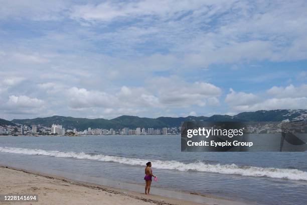 Woman is seen at the seashore enjoy the touristic beach during the resumption of tourist centers amid Covid-19 pandemic on August 21, 2020 in...