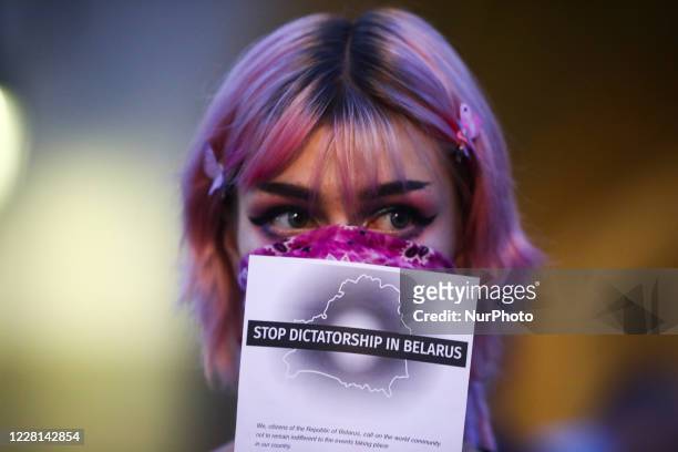 Girl attends a demonstration at the Main Square in solidarity with Belarus. Krakow, Poland on August 20, 2020. Belarusians living in Krakow and...