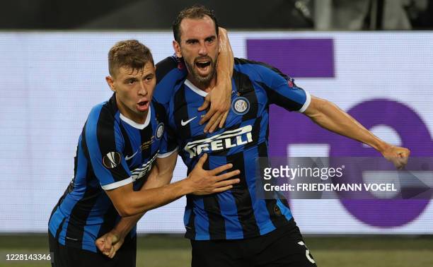 Inter Milan's Uruguayan defender Diego Godin celebrates scoring the 2-2 goal with his team-mate Inter Milan's Italian midfielder Nicolo Barella...