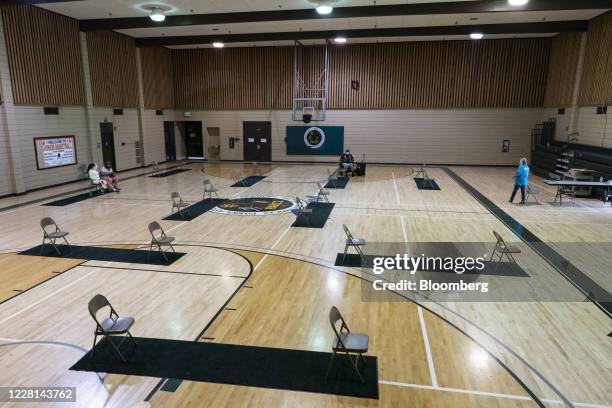 People sit inside a public cooling shelter at a community center in Fresno, California, U.S., on Wednesday, Aug. 19, 2020. On Tuesday -- just as...